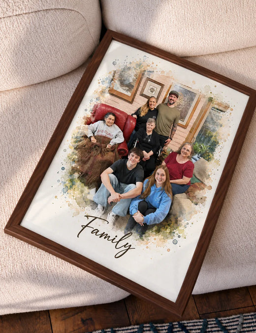 A framed watercolor portrait of a large family tilted on a cream sofa