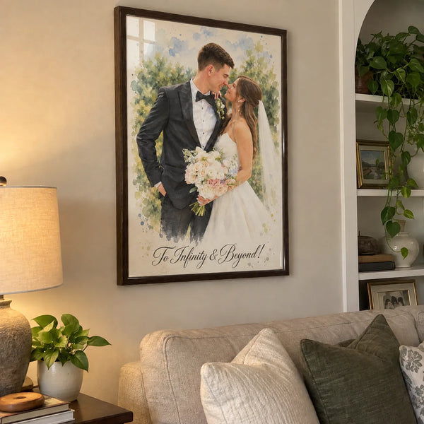 A framed watercolor portrait of a bride and groom hangs on a wall above a sofa.