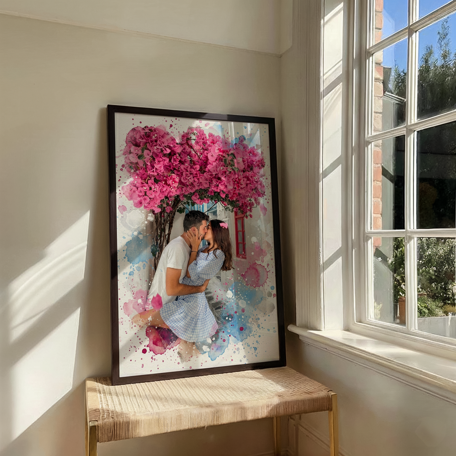 Large framed personalized watercolor print of a couple kissing under bright pink bougainvillea, with blue and magenta paint splatters.