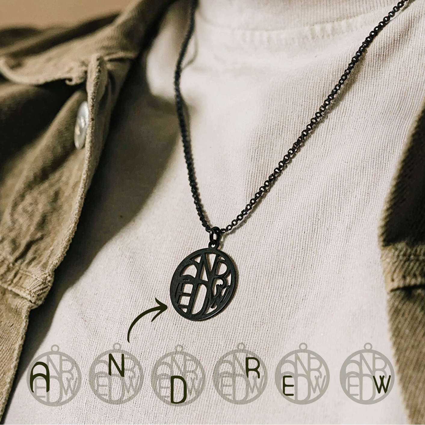 Man wearing black monogram necklace 