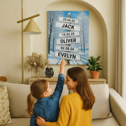 A mother and daughter sitting on a sofa point to a canvas on the wall that depicts a snowy winter forest with street signs displaying names like "JACK," "OLIVER," and "EVELYN" along with specific dates.