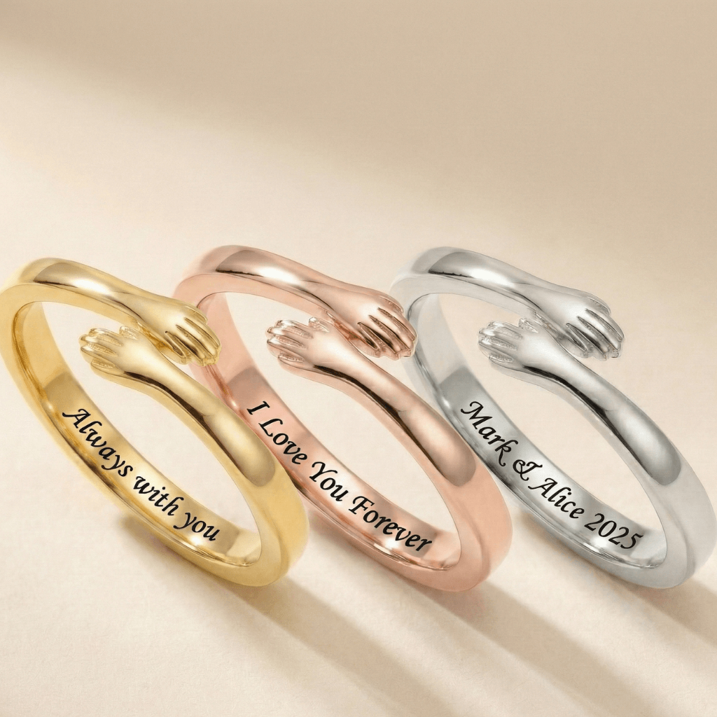 Close-up of 3 adjustable hug ring with small hands design, with each different engravings 
