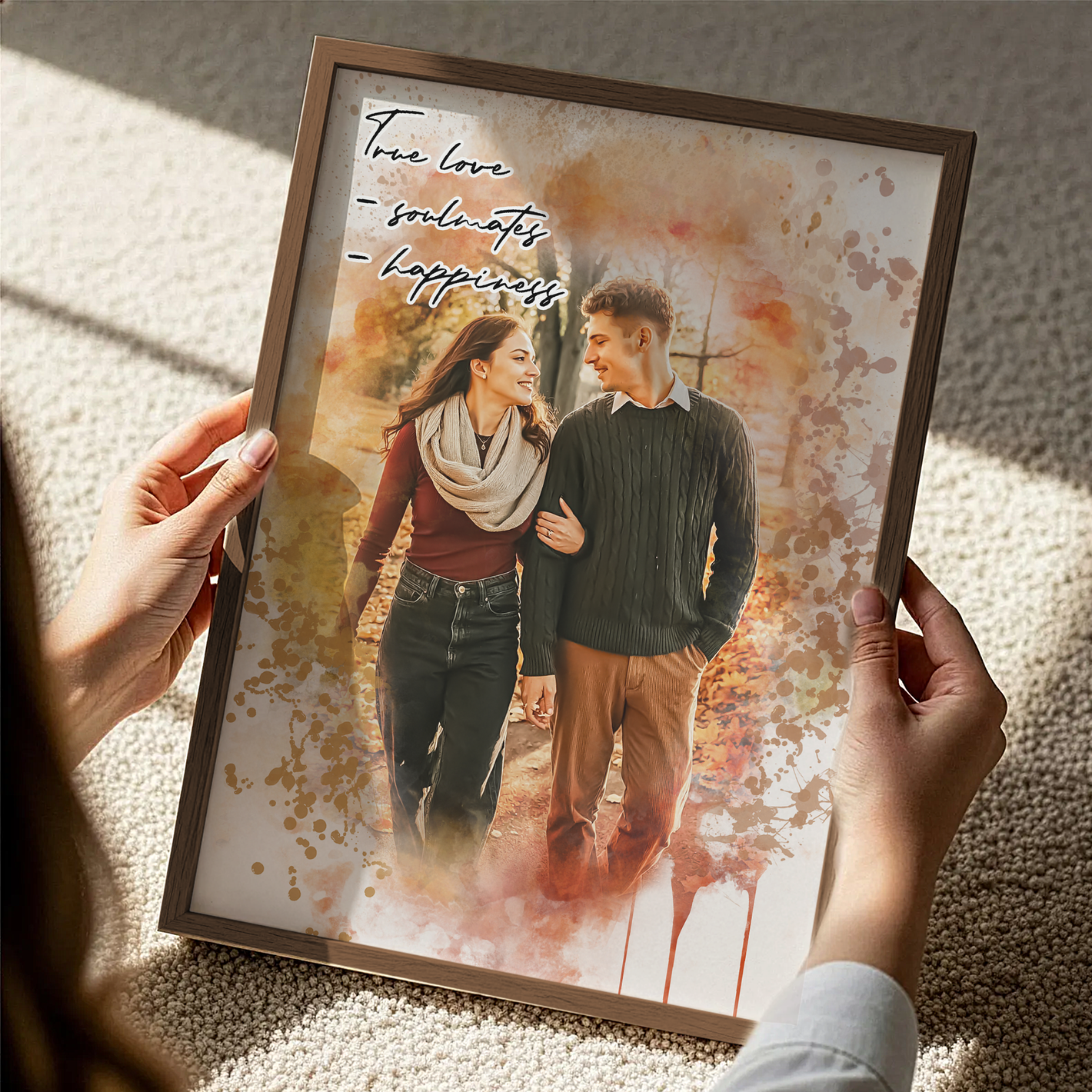 woman's hands holding a framed fall themed personalized couples portrait 