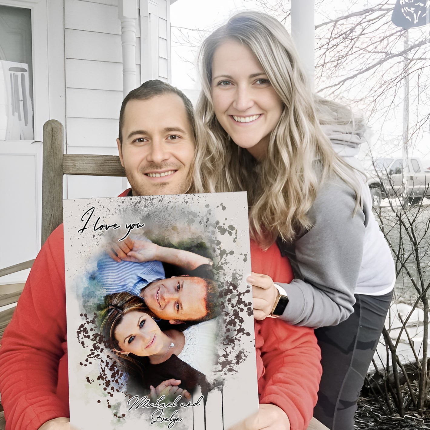 couple sitting outside smiling and holding a personalized couples portrait  