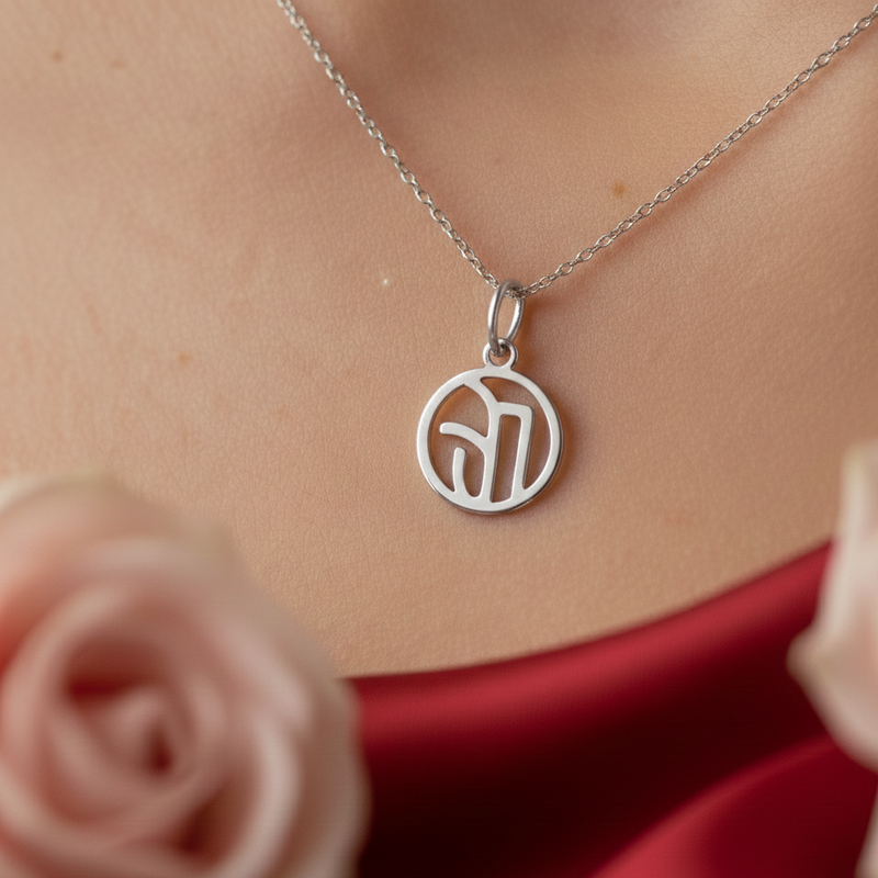 silver monogram necklace on woman's neck 