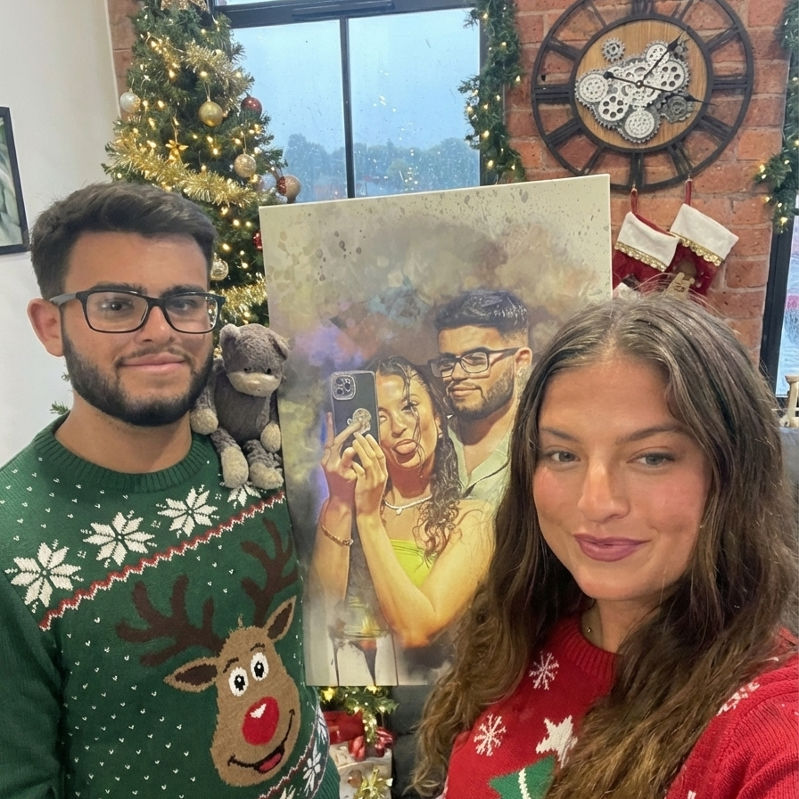 Couple in Christmas sweaters holding Couples Canvas