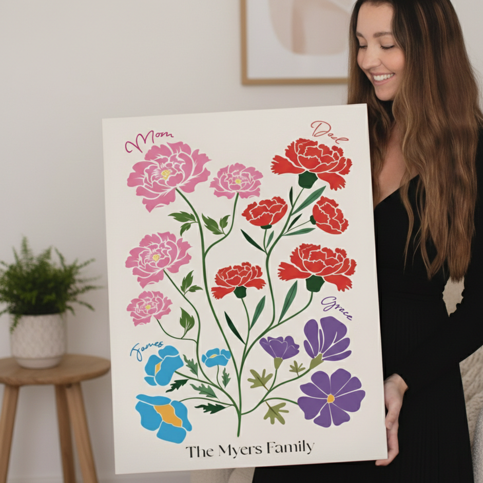 woman smiling and holding a portrait of illustrated birth flowers 