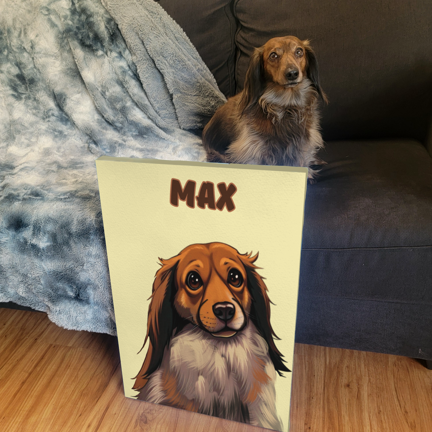 small breed dog sitting on a couch while a personalized illustrated artwork leans against the couch 