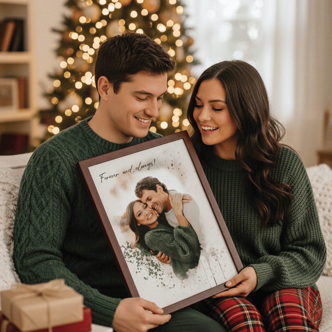 Couple sitting and holding a couples portrait frame of themselves