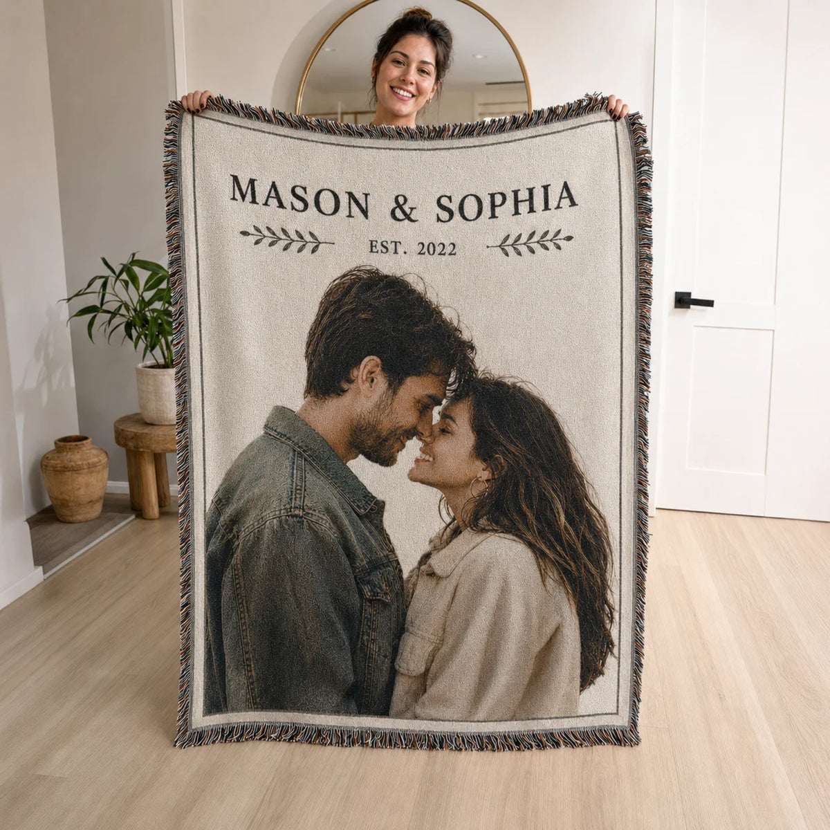 Minimal custom couple woven blanket in the Simply Us design held up, with laurel sprigs, names and est. year