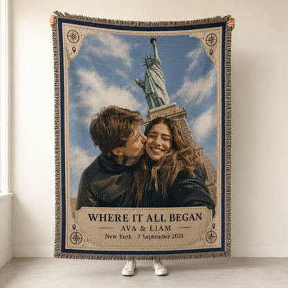 Travel keepsake couple woven blanket in the Where It All Began design held up, with compass corners, names, place and date