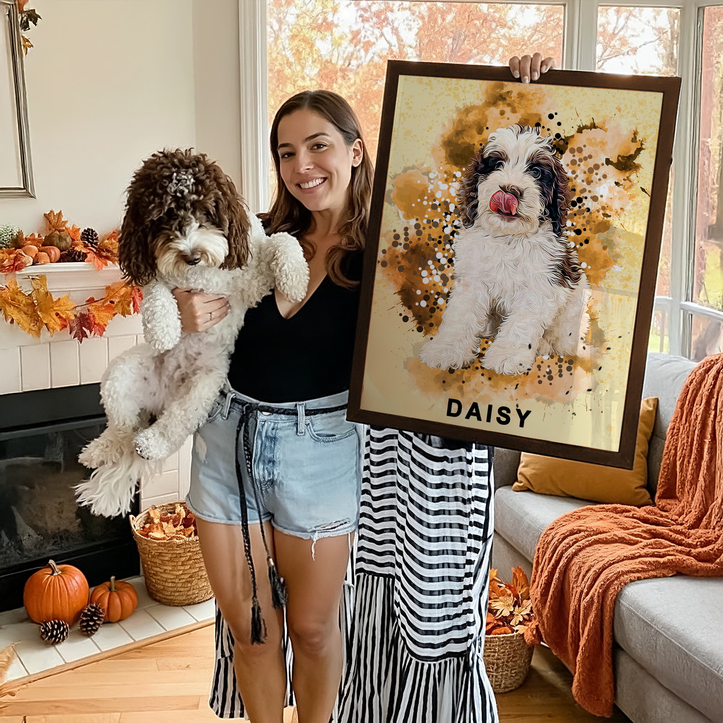 woman holding her dog in one hand and a framed custom illustration poster 