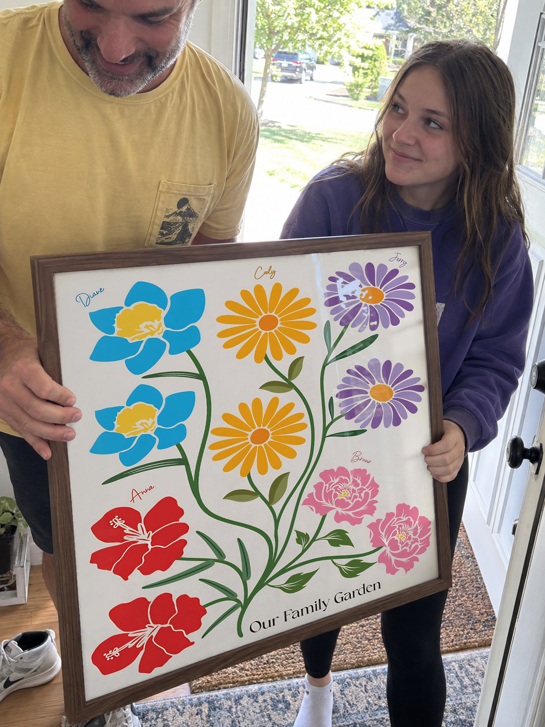Dad and daughter carrying the garden through the front door