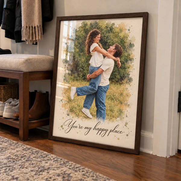 A framed watercolor portrait of a couple lifting each other in a meadow leans in a hallway.