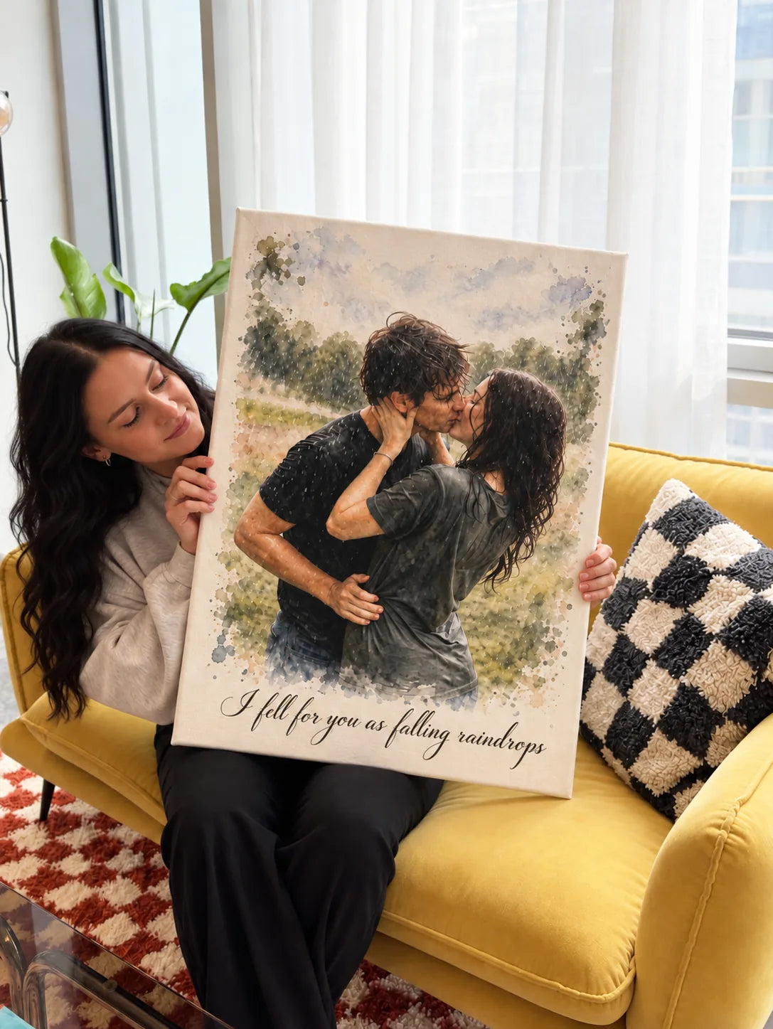 A woman smiles from behind a canvas watercolor portrait of a couple kissing in the rain.