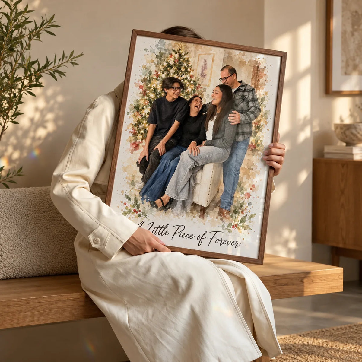 A woman holding a framed family portrait with a Christmas tree behind the family